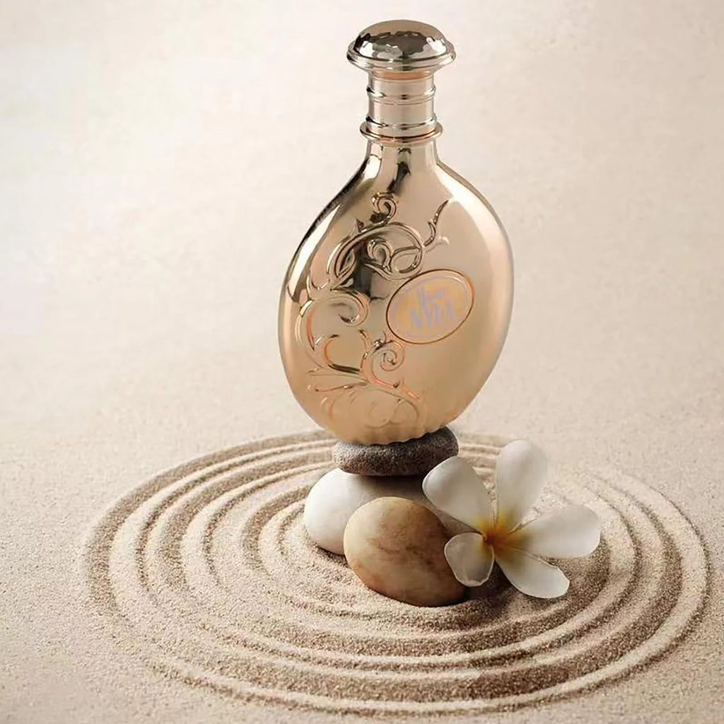 Nyla Vani-Elle Eau de Parfum bottle on sand with spa stones and white flower
